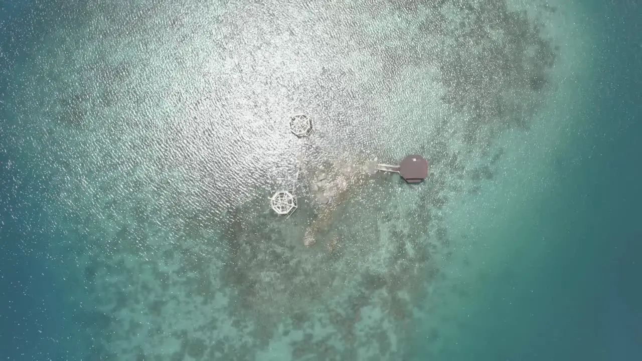 Top-down View Of A Luxury Cottage Resort In The Middle Of A Crystal Clear Blue Water In The Tropical Island Of The Philippines On A Bright Weather