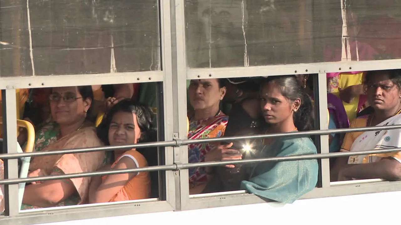 A bus drives with a full load of passengers