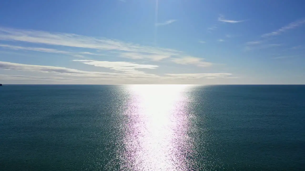 Aerial flying over ocean during sunny day background dolly movement