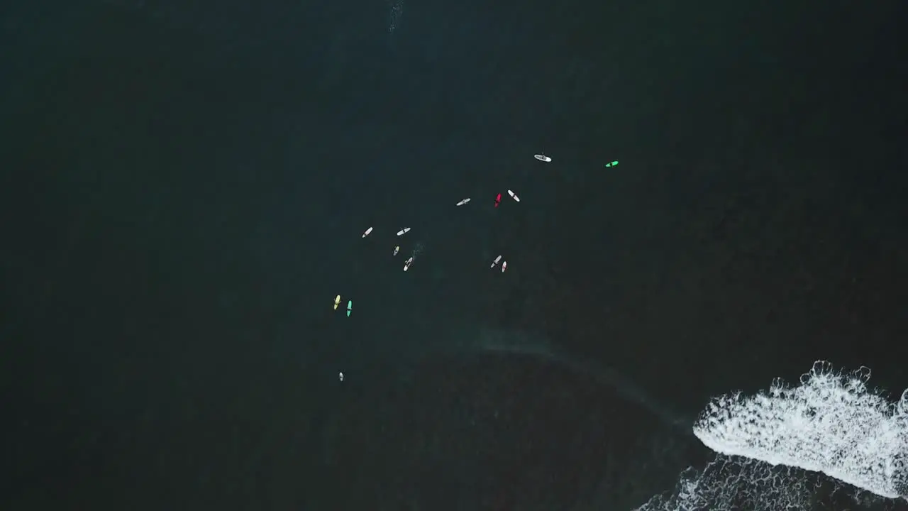 Top down view of paddleboarders with waves in Hanalei Bay in Kauai Hawaii at sunset