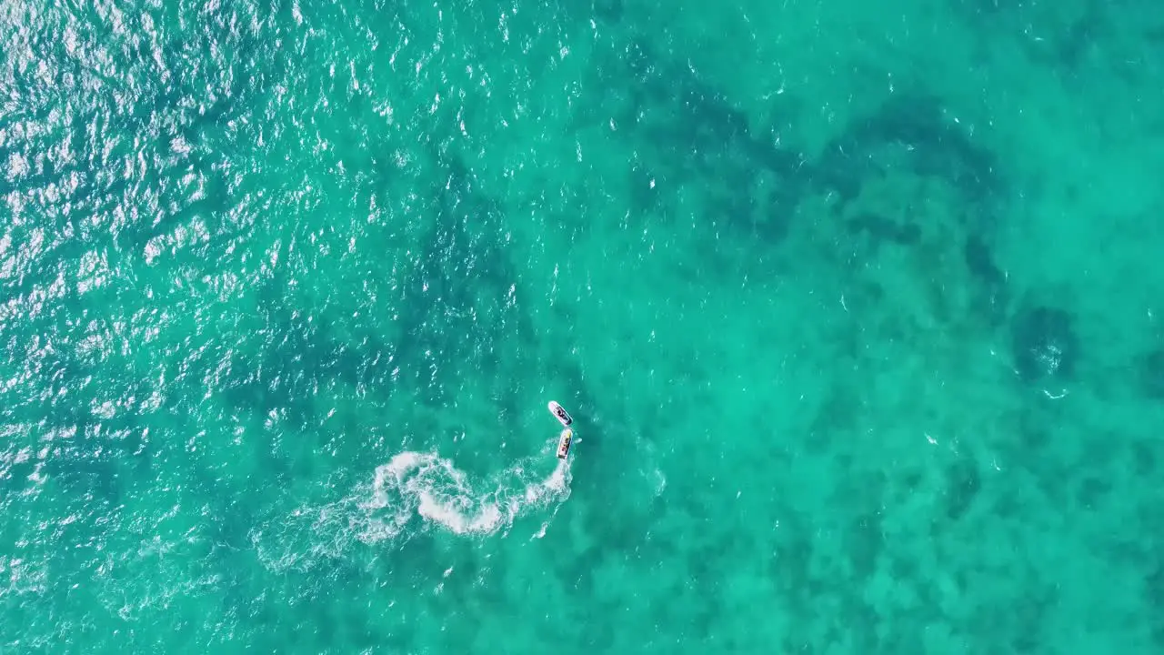 AERIAL Boat speeding through the beautiful turquoise waters of Cancun Mexico