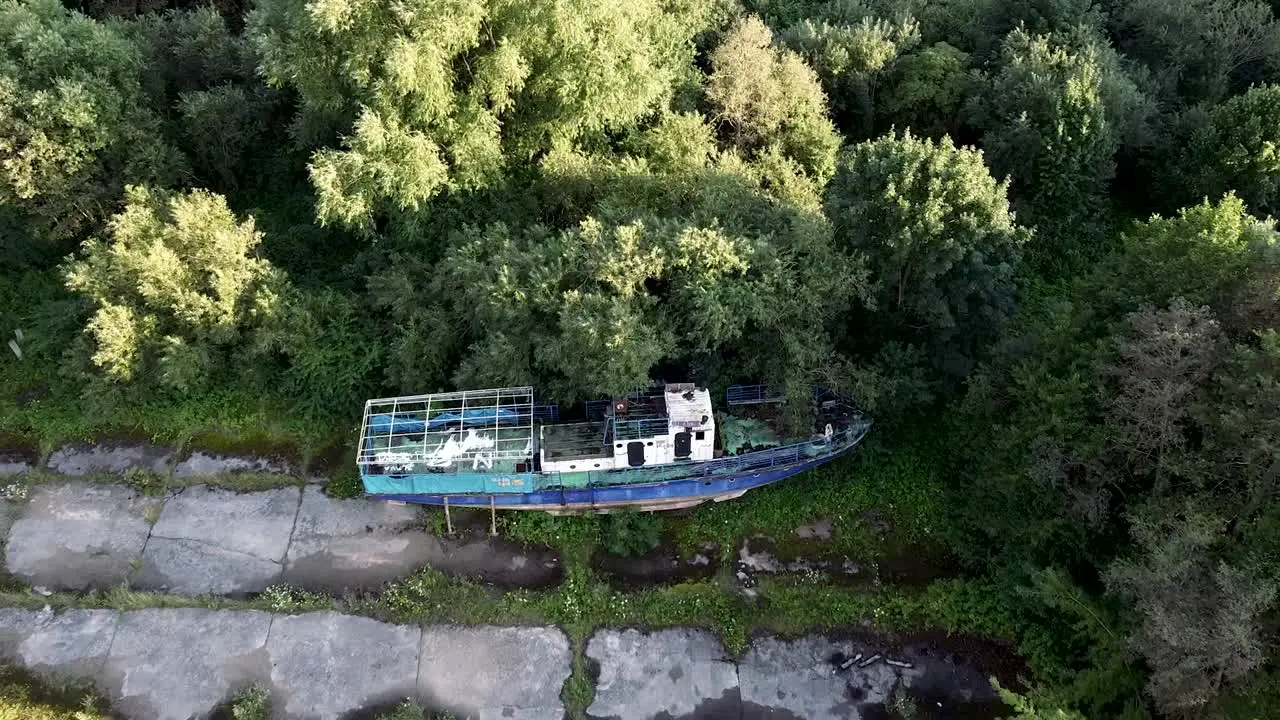 Arial shot of abandoned ship near the natural forest area