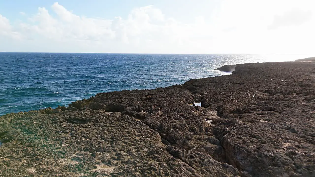 Jagged eroded cliffs from stong ocean waves on northside of Curacao at midday