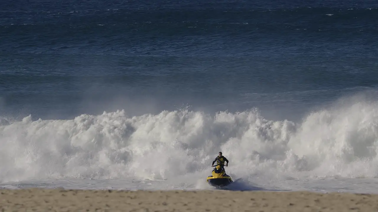 Jet ski escaping big ocean wave in Nazare Portugal getting away from danger water