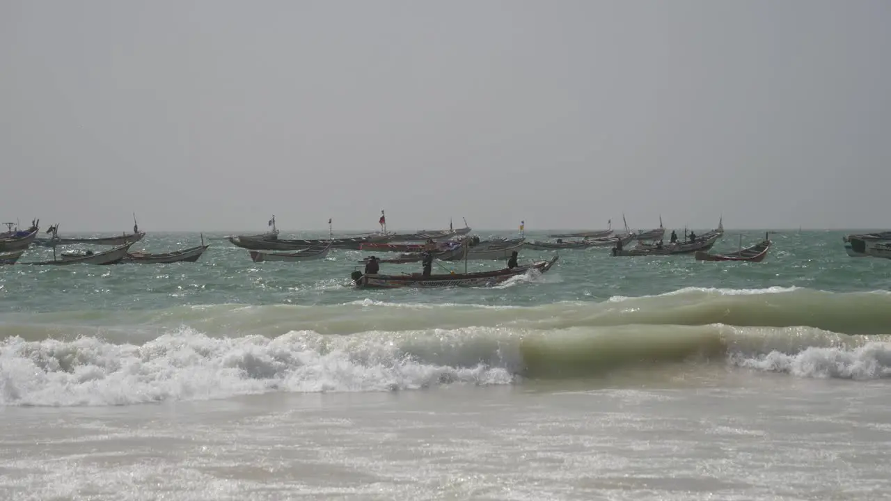 Fishing Boats and Fishermen Sailing on Rough Ocean by the Beach in Mauritania