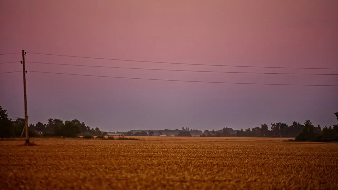 Sunset to nighttime with a super moon rising over farmland time lapse