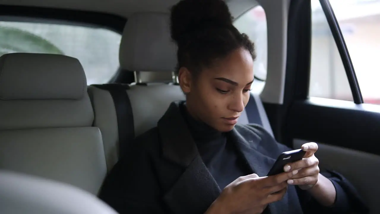 Beautiful Woman Heading By Car To An Important Meeting And Typing On Her Cellphone