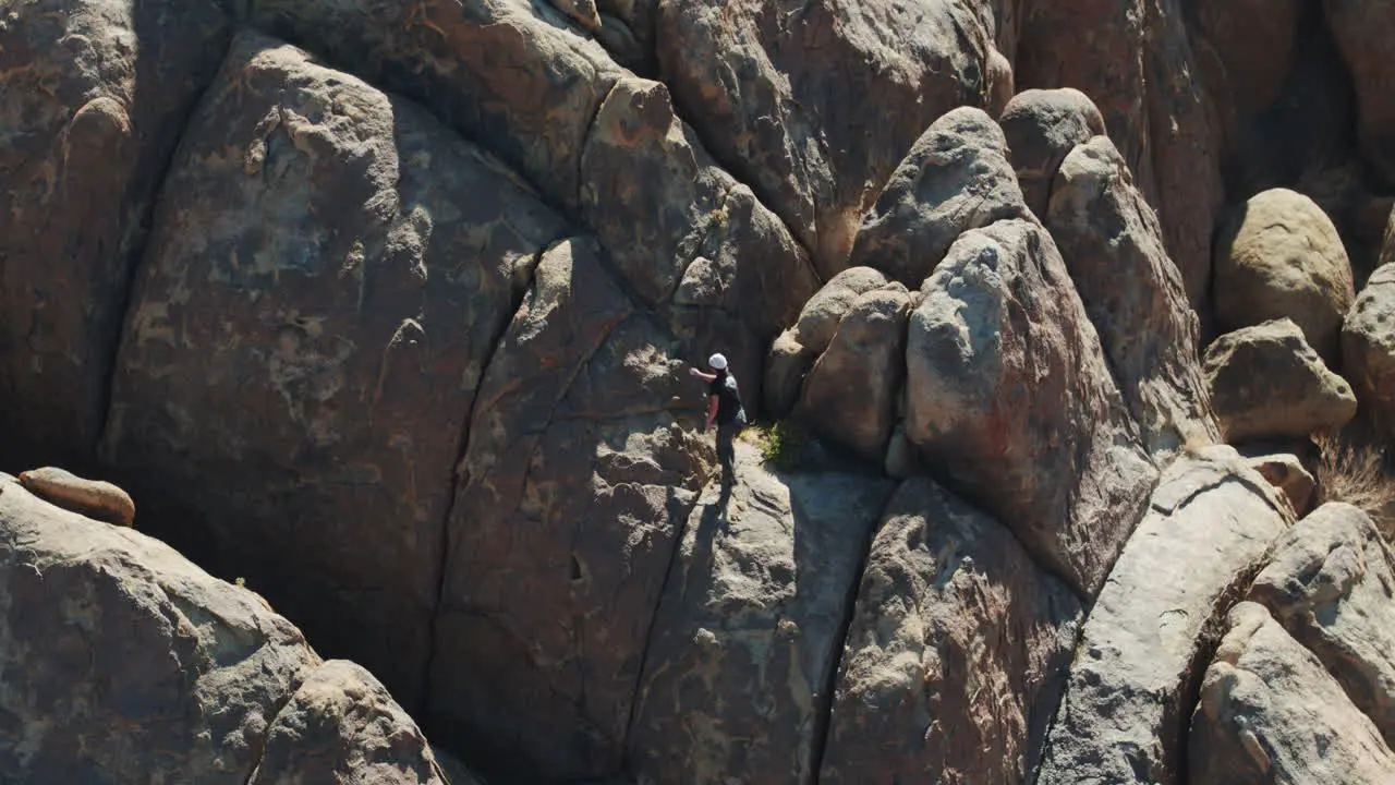 Man bouldering on rocks in Alabama Hills on sunny day aerial