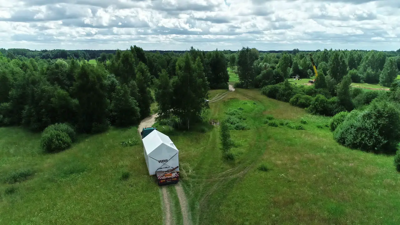 Pre-fabricated modular house trasported by truck on country road in Latvia