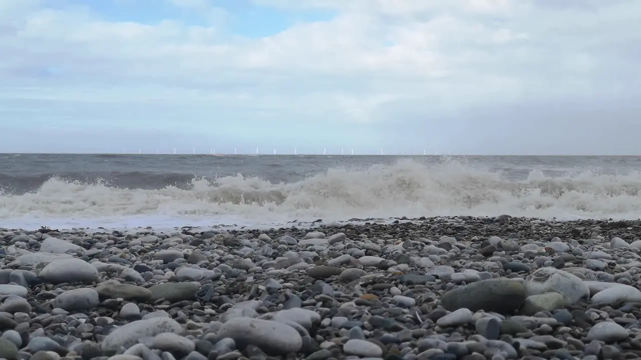 February 2022 storm Eunice crashing waves on Welsh stone pebble beach