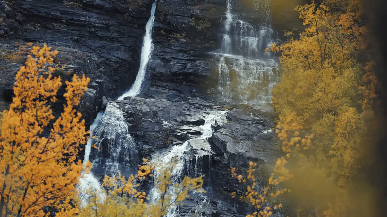 A waterfall above the autumn forest