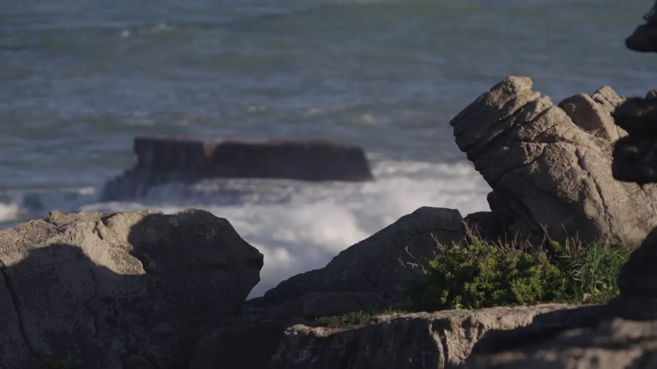 Eroded stone rocks and ocean waves in background Portugal coast near Peniche