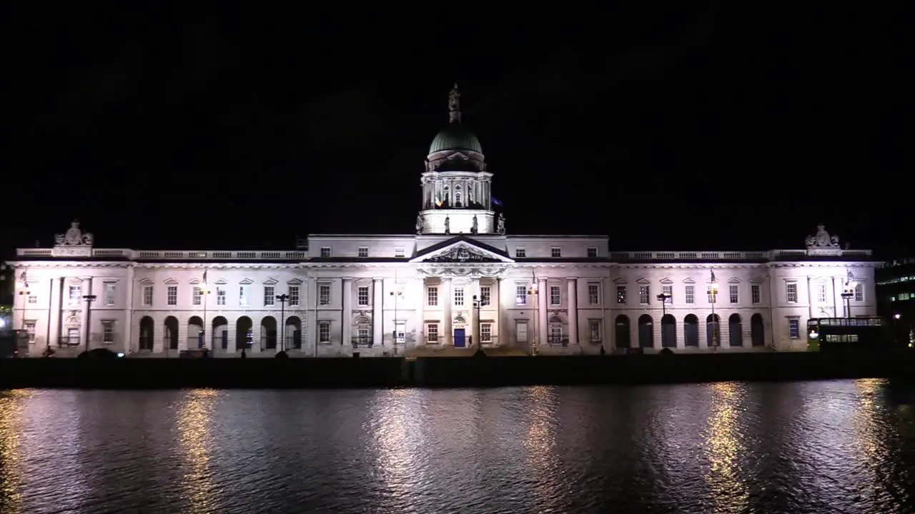 Still shot of the Irish Custom House in November fully illuminated with lights with river Liffey