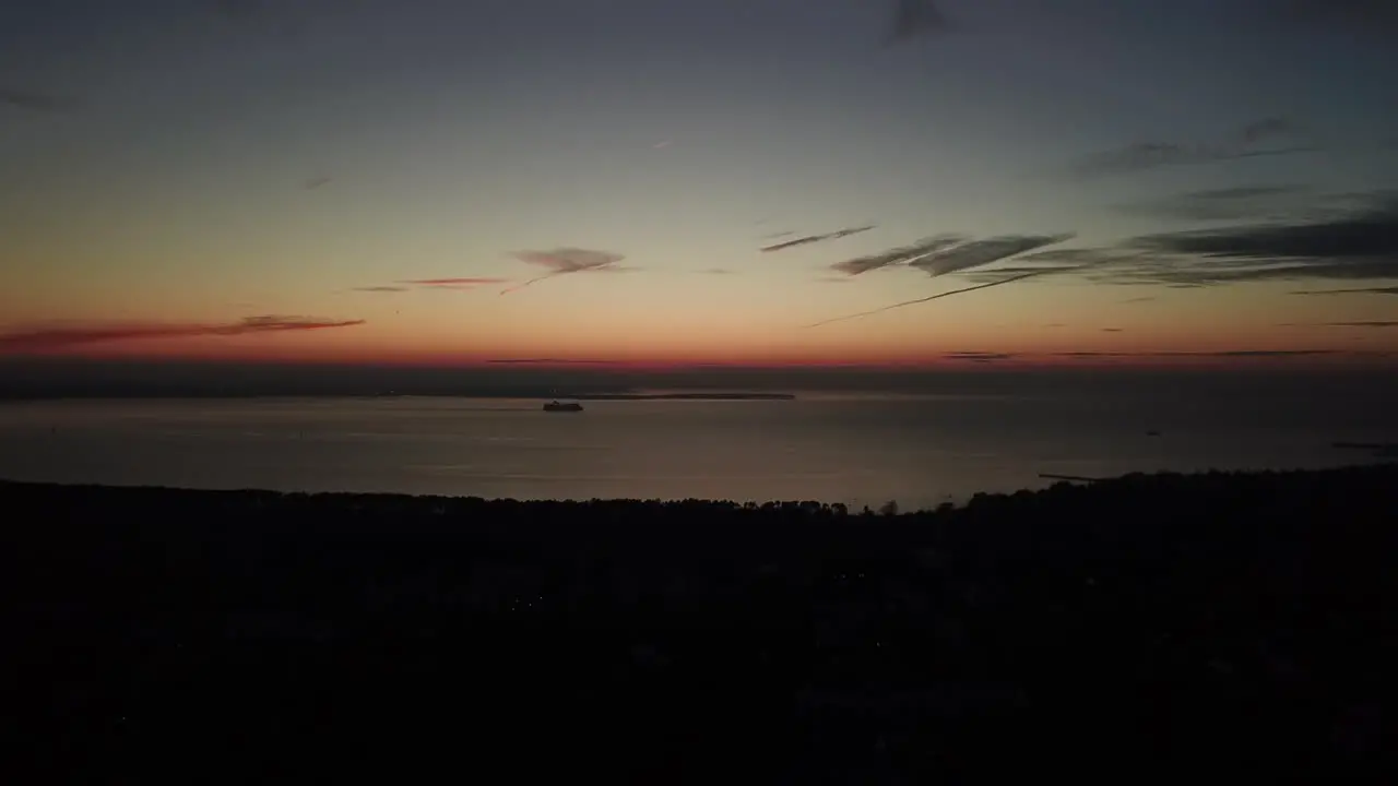 A ship moving on the ocean coastline on the evening