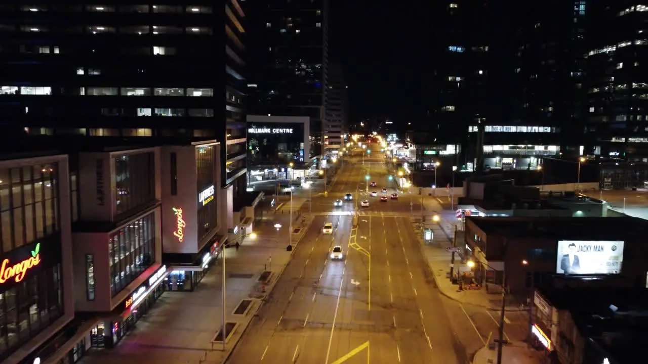 Night drone flight along illuminated Yonge street in Toronto Canada