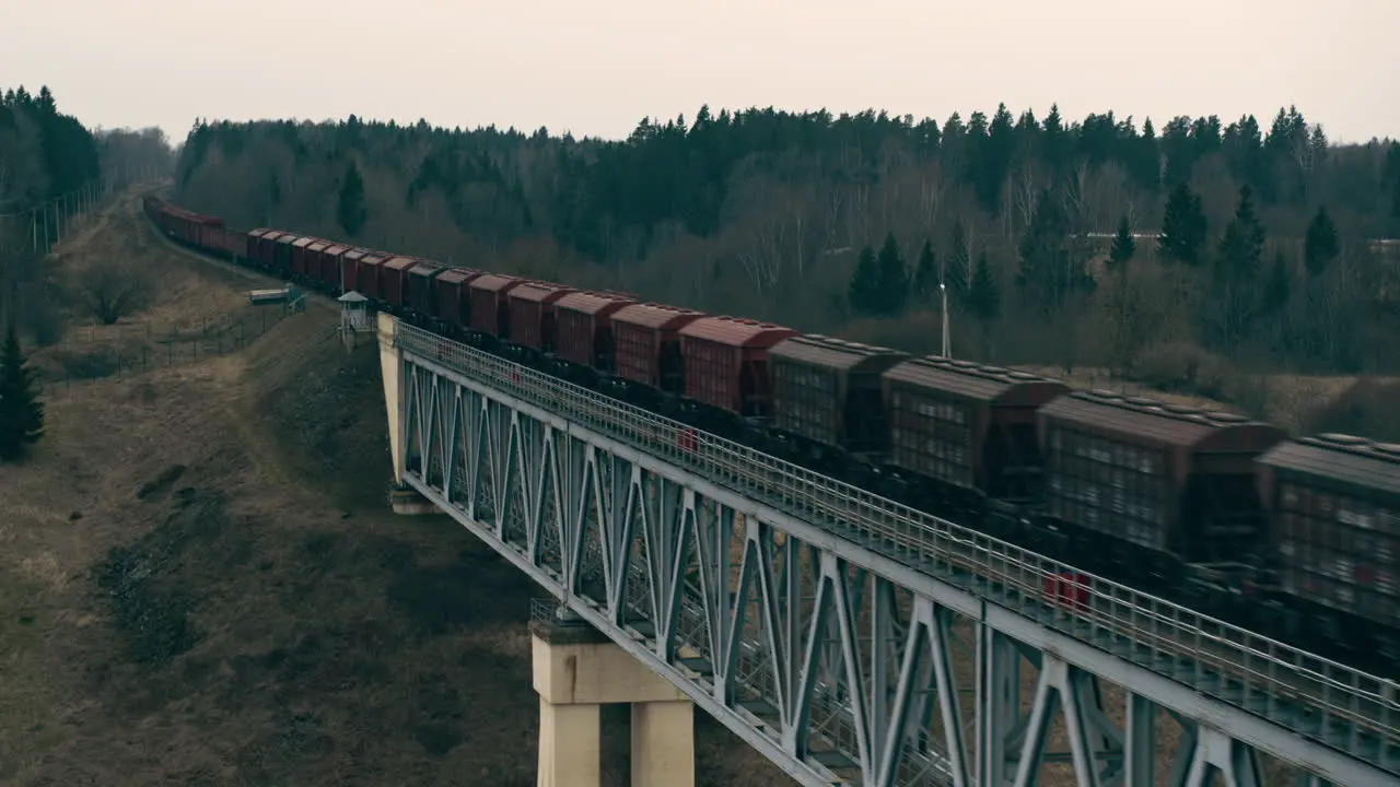 Aerial view of cargo train riding on the bridge