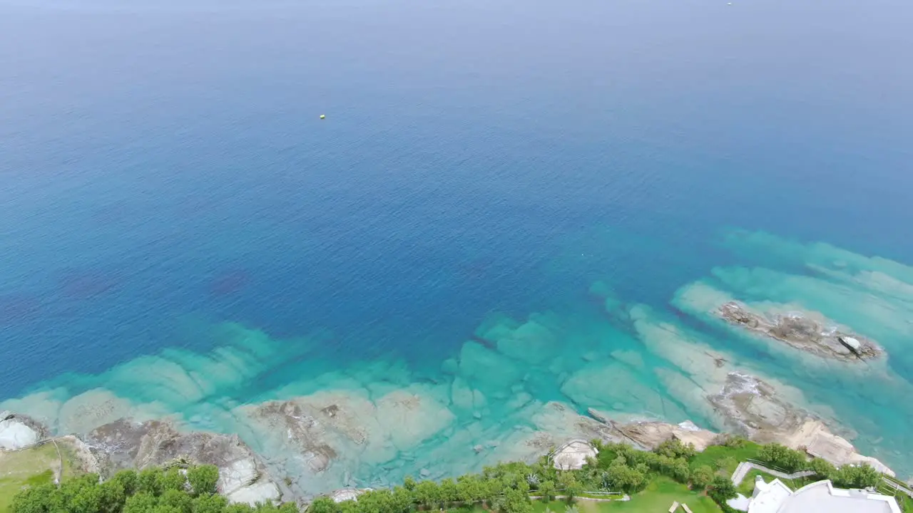 Aerial forward over luxury seaside houses on Crete coast in Greece