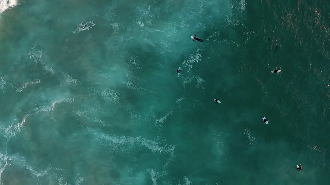 Happy Surfers Paddling And Gliding Through Turquoise Blue Waters At Llandudno Beach Cape Town In South Africa