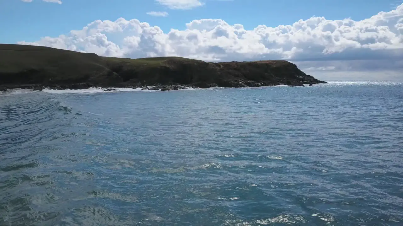 Tracking shot of ocean wave moving toward Emerald beach and Look At Me Now Headland Australia