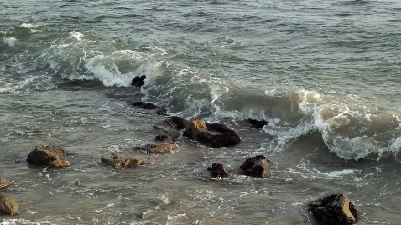 Reminiscing memories with waves hitting rock stones on the beach of Big Rock in Malibu California