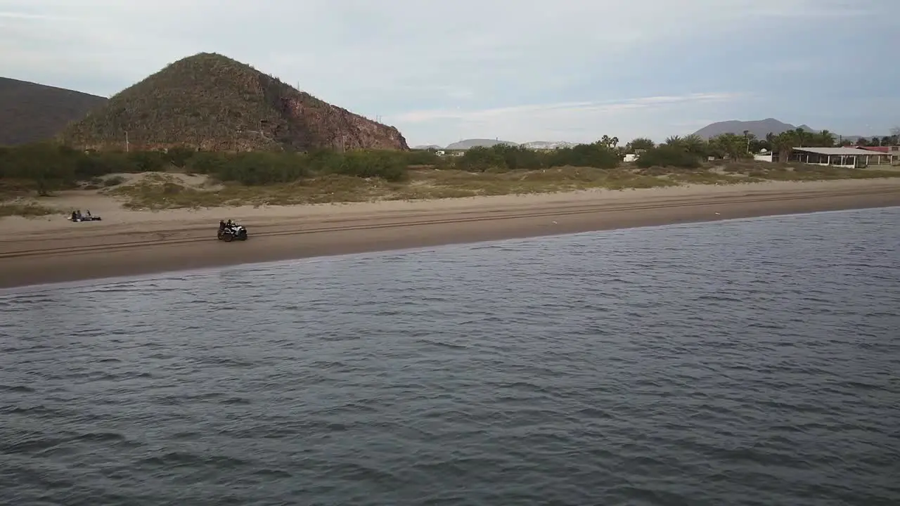 Strolling on the beach aboard a motorcycle