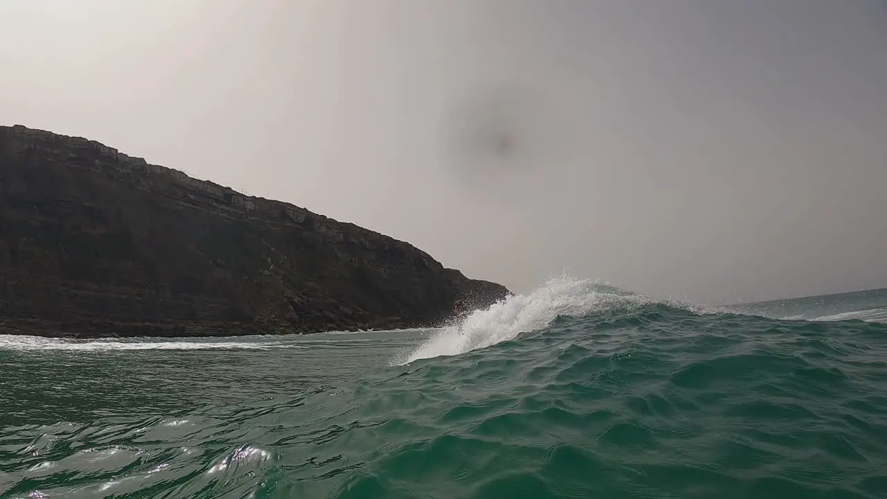 Surfer surfing tropical ocean wave attacking off the lip in Aguda Portugal