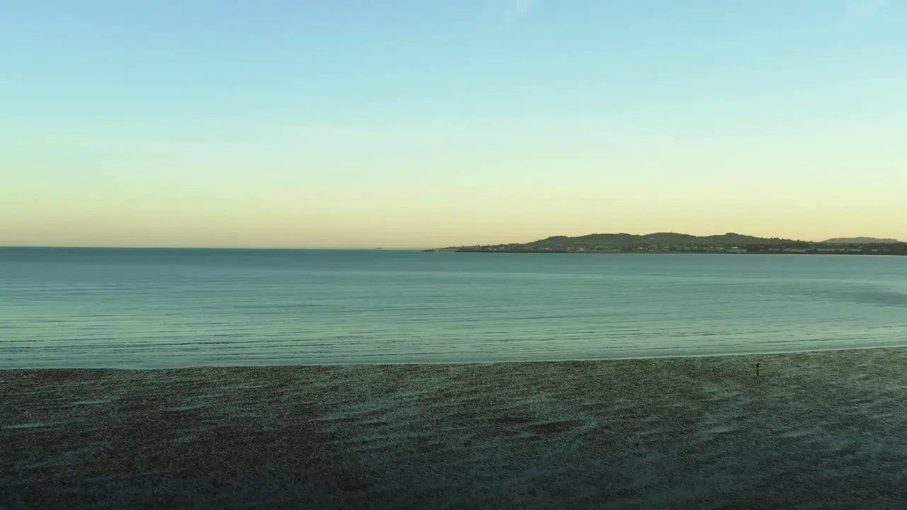 Aerial of Beautiful low tide at Dublin Ireland coast at sunset dolly in