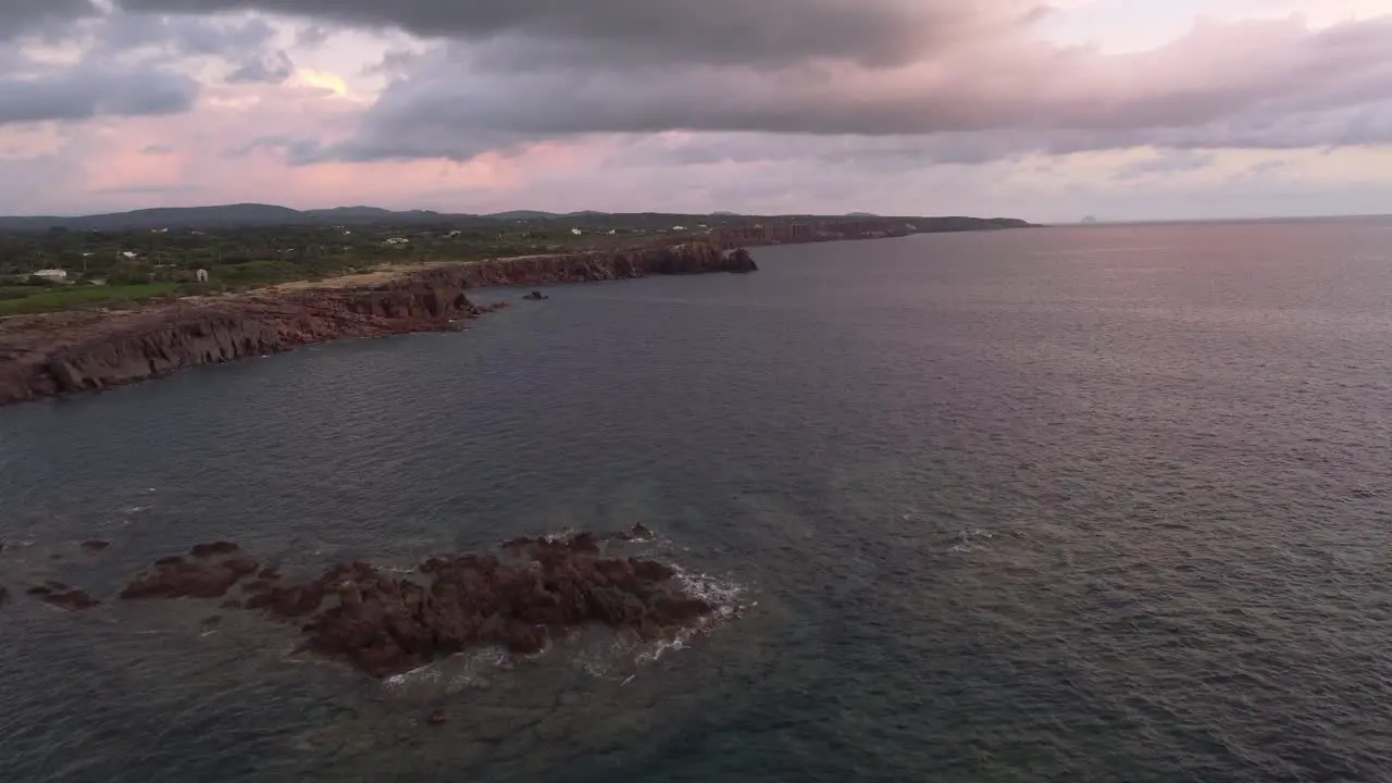 Sensational aerial drone view of cliff coastline at sunset Sardinian landscape