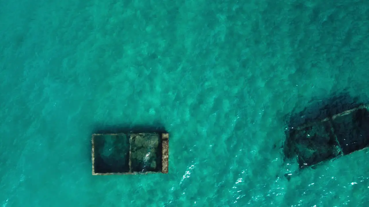 Sensational aerial top down view of underwater tubs surround by turquoise water