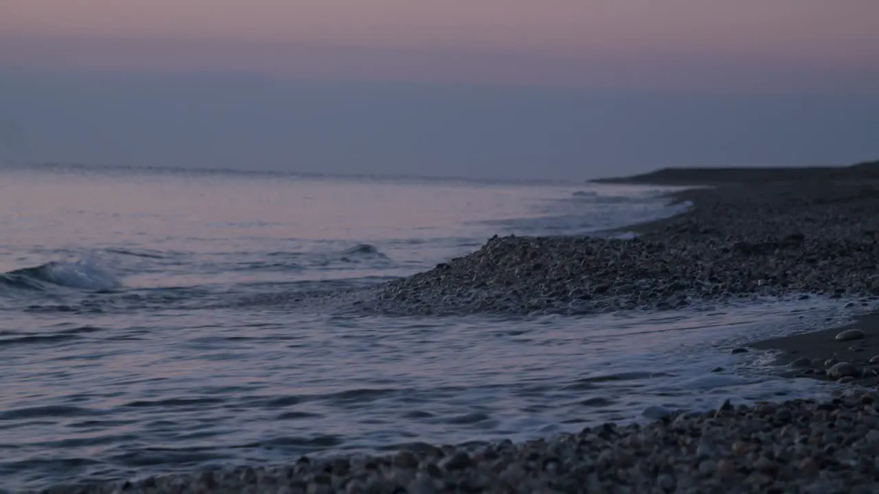 Focused shoreline waves crashing rocky beach sunrise Mojacar Almeria Spain