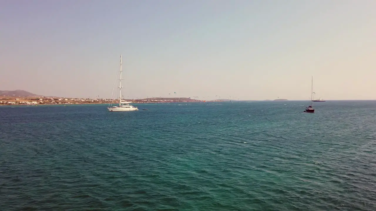 Static Shot From A Cruise Of Two Large Boats With People Kitesurfing In The Background