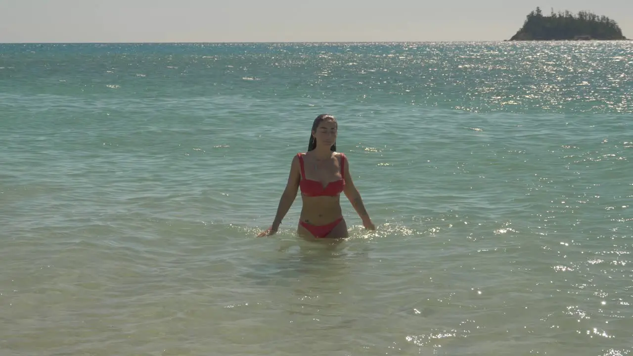 Woman In Bikini On Glistening Water At Summer Beach Of Langford Island Whitsundays In Queensland Australia