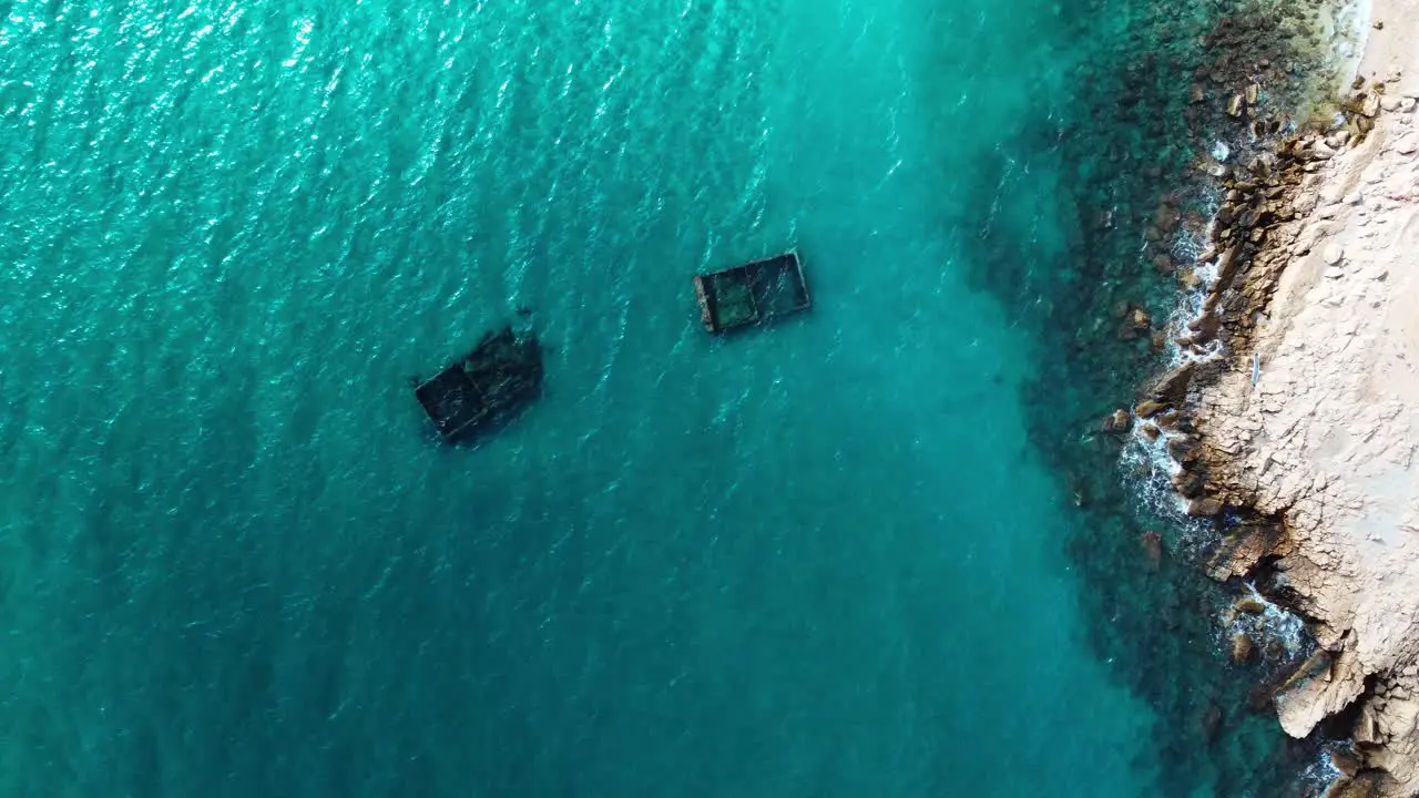 Top down aerial view of archeological structures immersed in turquoise water