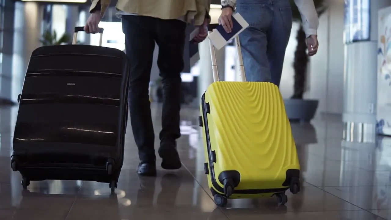 Pair Of Travelers Are Carrying Their Luggage And Passports