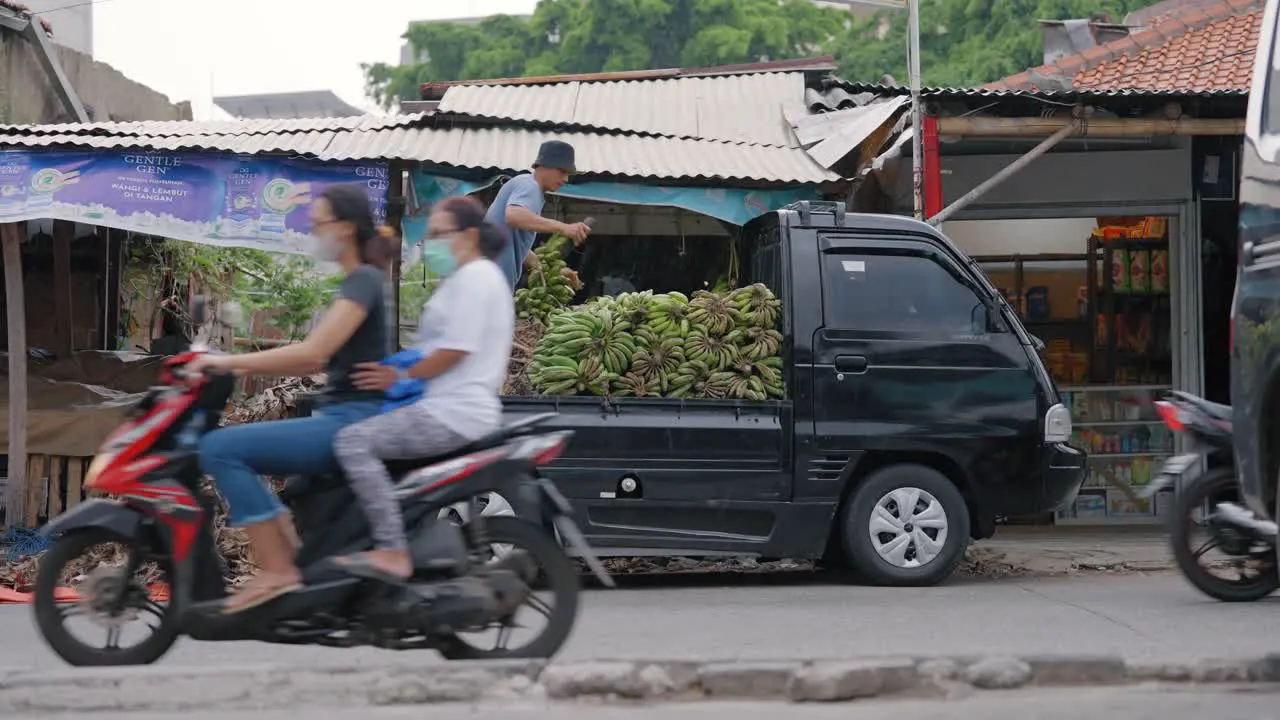 Wide Shot of Workers Unloading Bananas from Van